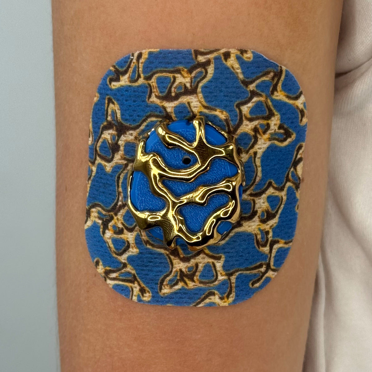 Blue Venom CGM patch with a gold finish for Dexcom G7