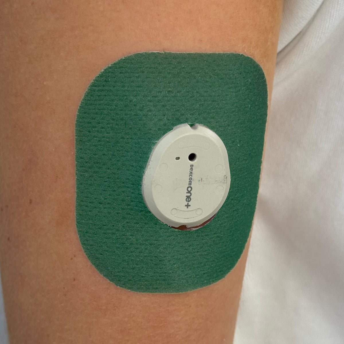 Green Everyday CGM patch for Dexcom G7, worn on the body