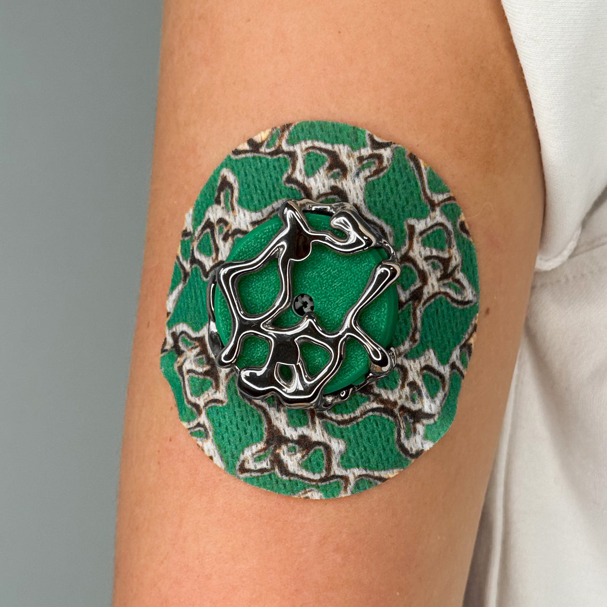 Green Venom CGM patch with a silver finish for Libre 2