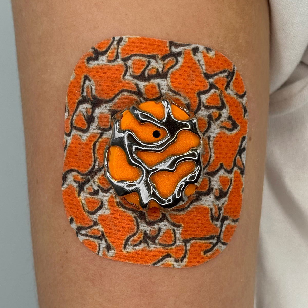Orange Venom CGM patch with a silver finish for Dexcom G7
