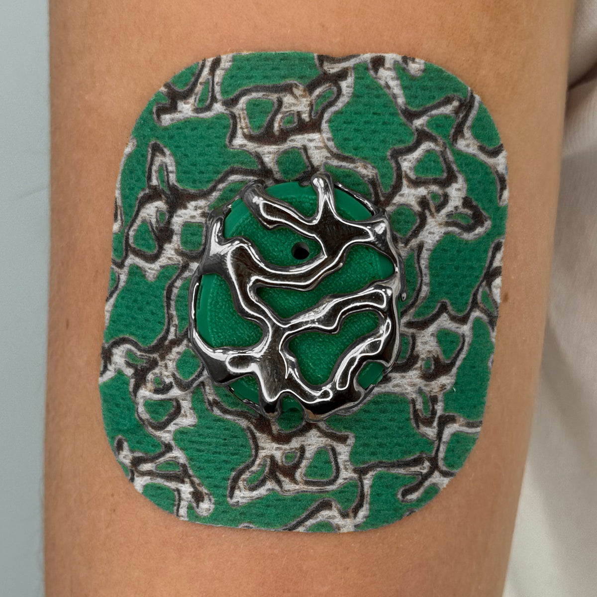 Green Venom CGM patch with a silver finish for Dexcom G7