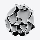 A highly polished, abstract sculptural jewelry piece with a glossy silver finish and black recessed details, shown on a clean white background.