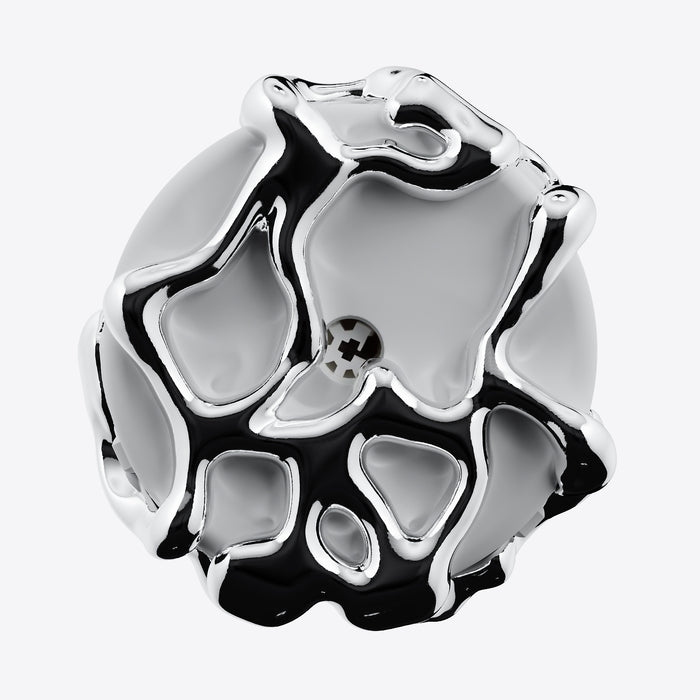 A highly polished, abstract sculptural jewelry piece with a glossy silver finish and black recessed details, shown on a clean white background.