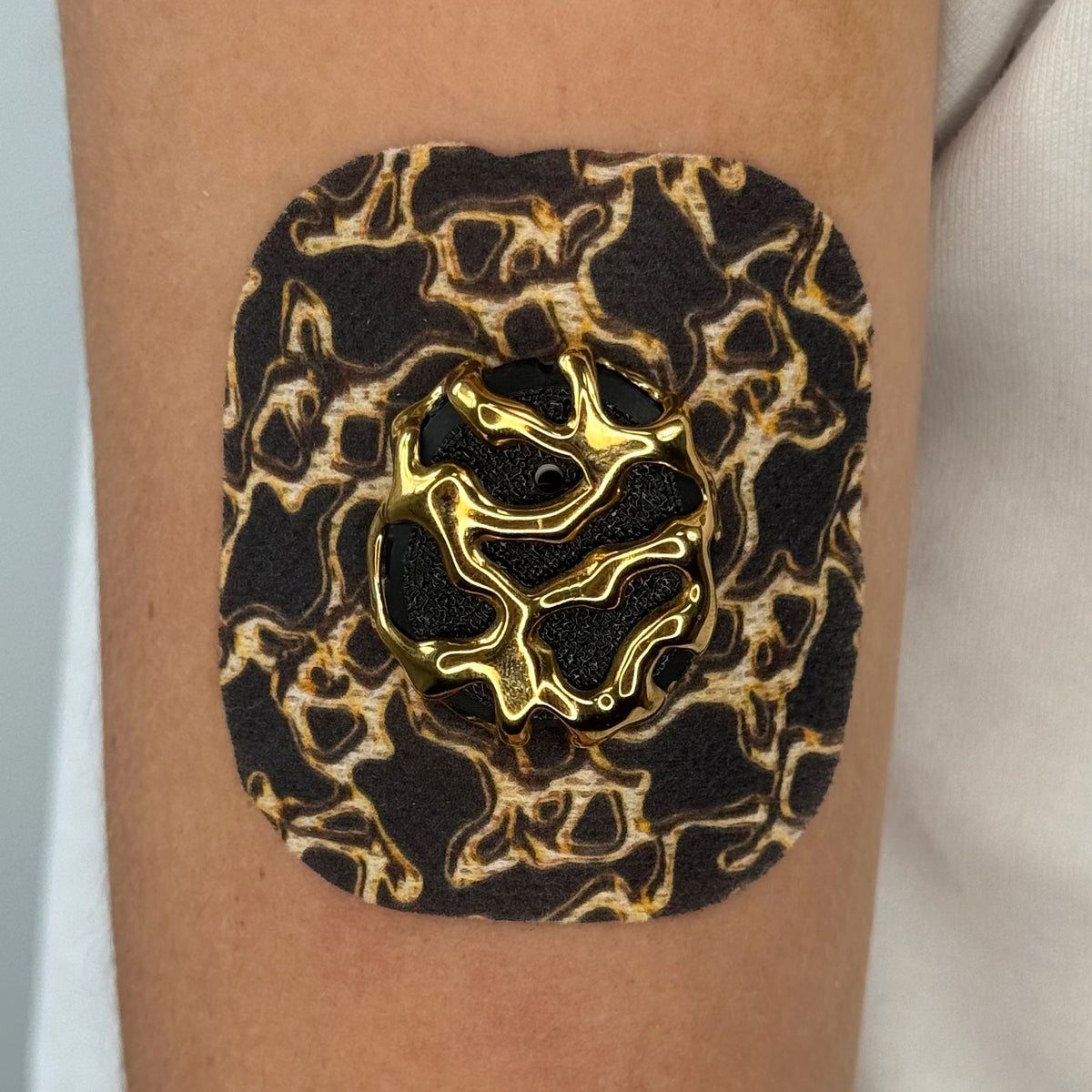Black Venom CGM patch with a gold finish for Dexcom G7