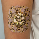 Beige Venom CGM patch with a gold finish for Dexcom G7