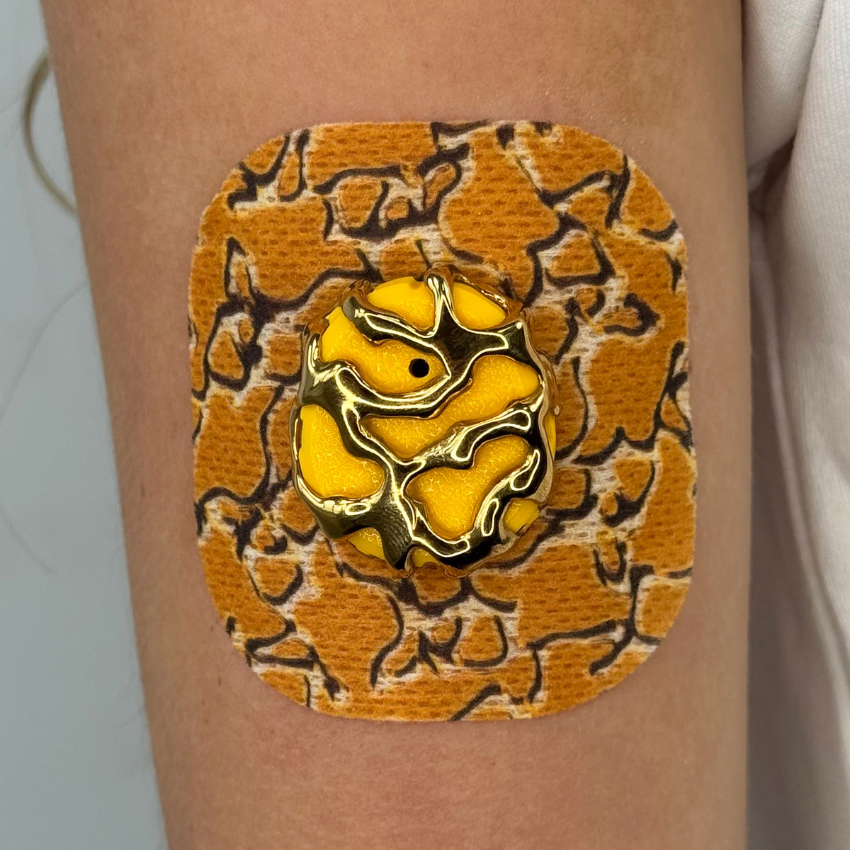 Yellow Venom CGM patch with a gold finish for Dexcom G7