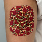 Red Venom CGM patch with a gold finish for Dexcom G7