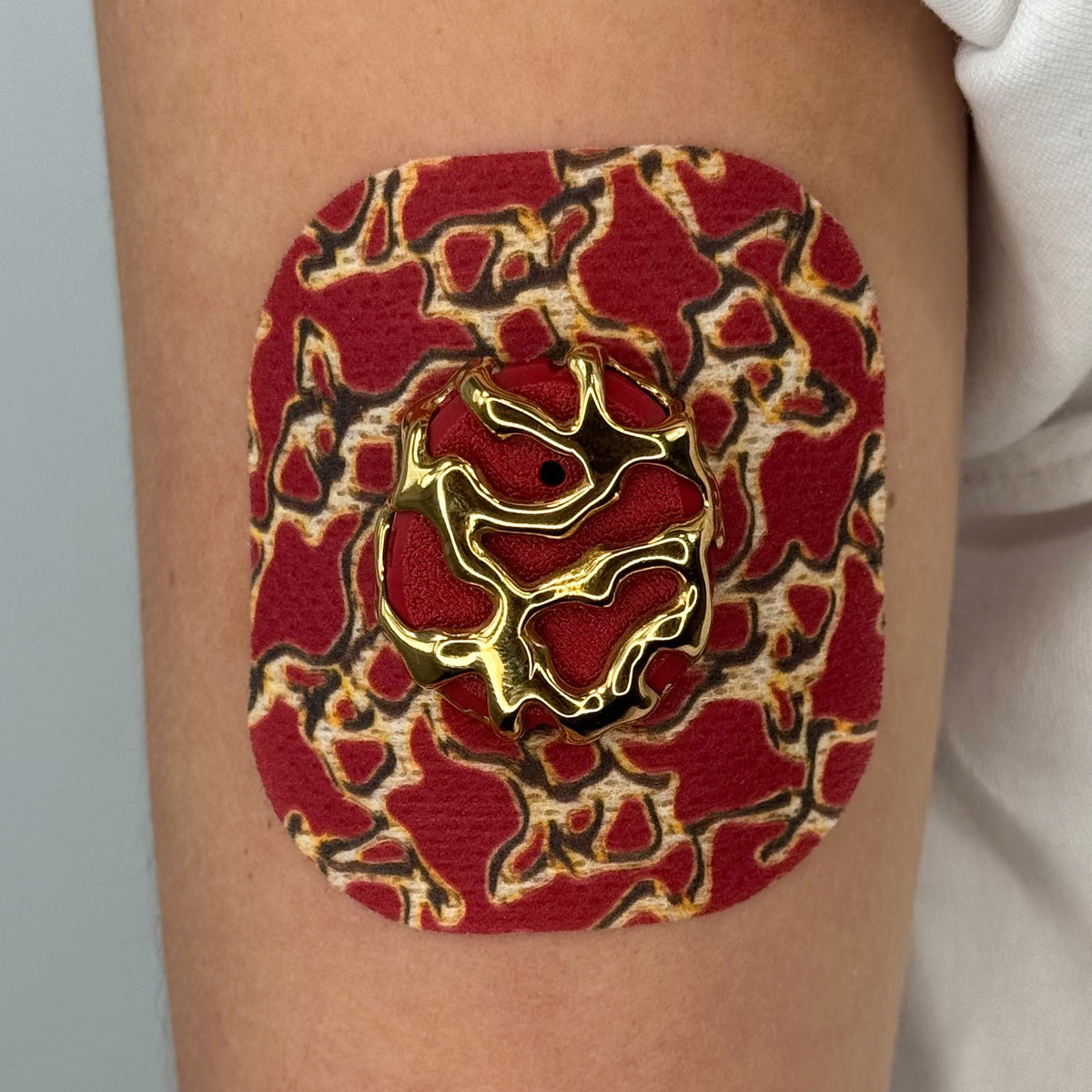 Red Venom CGM patch with a gold finish for Dexcom G7