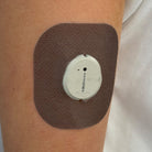 Brown Everyday CGM patch for Dexcom G7, worn on the body