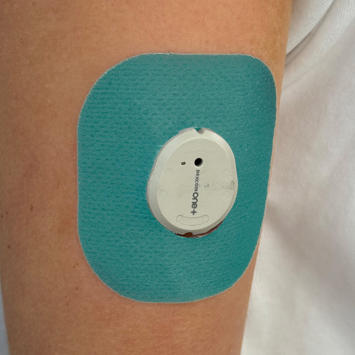 Cyan Everyday CGM patch for Dexcom G7, worn on the body