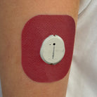 Red Everyday CGM patch for Dexcom G7, worn on the body