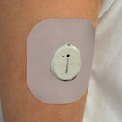Beige Everyday CGM patch for Dexcom G7, worn on the body