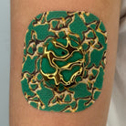 Green Venom CGM patch with a gold finish for Dexcom G7