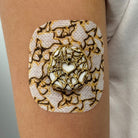 White Venom CGM patch with a gold finish for Dexcom G7