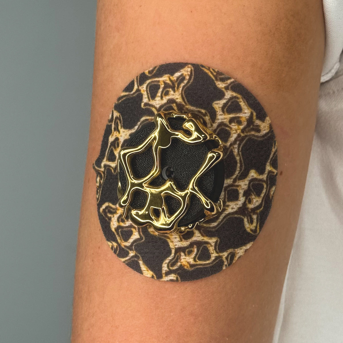 Grey Venom CGM patch with a gold finish for Libre 2