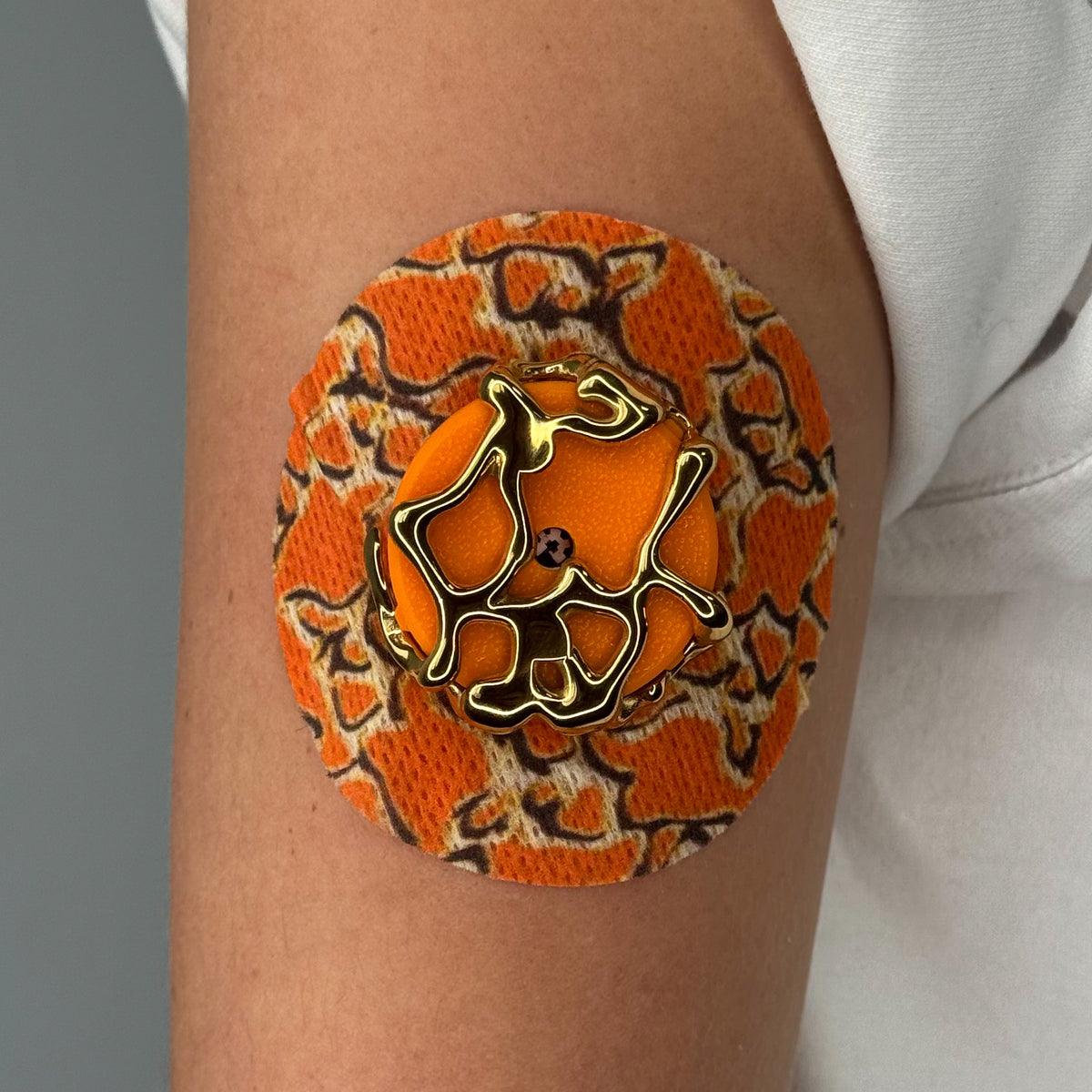 Orange Venom CGM patch with a gold finish for Libre 2