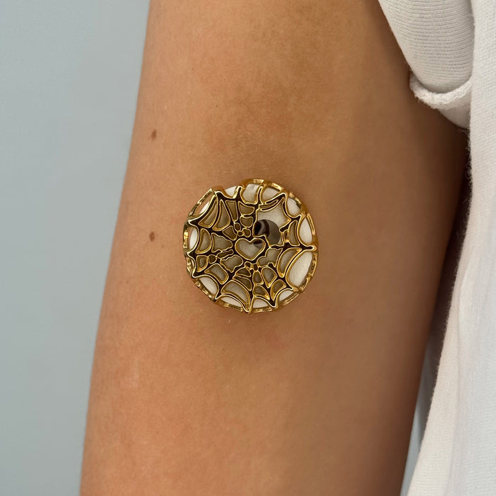 Gold Webbed Armour for Libre 3, worn on the arm